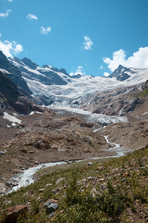 Landscape, mountain panorama, alpine meadows and mountain peaks in ice, a small house on the mountainsideの写真素材