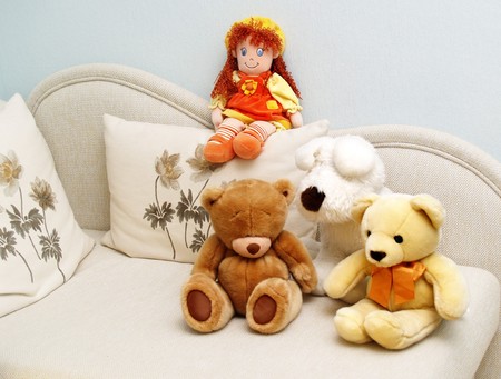 Soft toys on a white sofaの写真素材