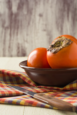 Juicy and ripe persimmon.Background.の写真素材