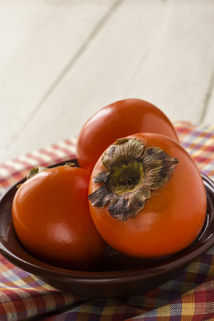 Juicy and ripe persimmon.Background.の写真素材