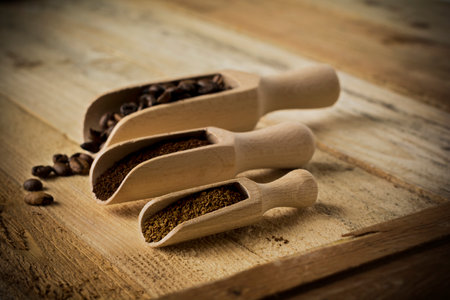 Three types of coffee in a wooden spoon on a wooden table.Toned image.Selective focus.のeditorial素材