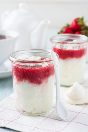 Strawberry rice pudding served in jar.Healthy breakfast. Selective focus.の写真素材