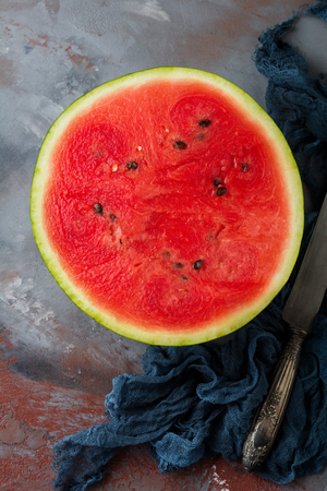 Fresh raw watermelon cut into pieces on  gray stone background. Selective focus. Top view. Copy space.の写真素材