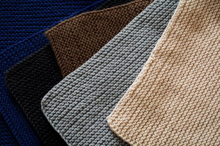 Mix of black, gray, blue Indigo, brown and beige knitted wool texture background pattern horizontal...