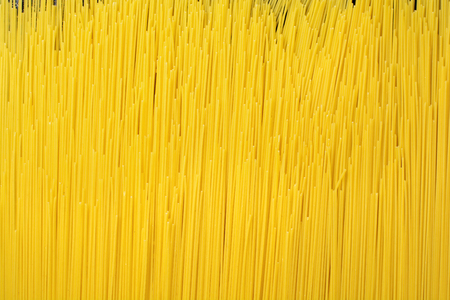 Abstract background texture of pasta closeup. Raw Spaghetti. Selective focuse. Top view.の写真素材