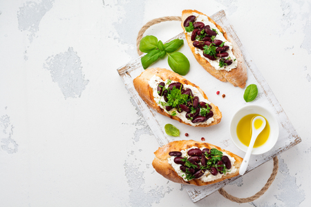 Sandwich with red beans, garlic, olive oil and curd cheese on white background. Mexican Cuisine. Top view.の写真素材