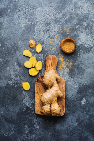 Ginger root on dark grey background. Top view.の写真素材