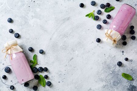 Fresh healthy blueberries smoothie berries and mint in glass jar on light white concrete background. Zero waste concept .Top view. Copy space.の写真素材