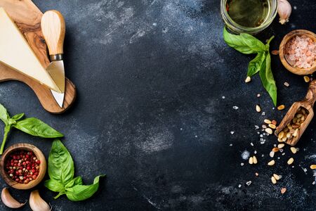 Ingredients for making traditional italian pesto sauce on old dark rustic background. Flat lay.の写真素材