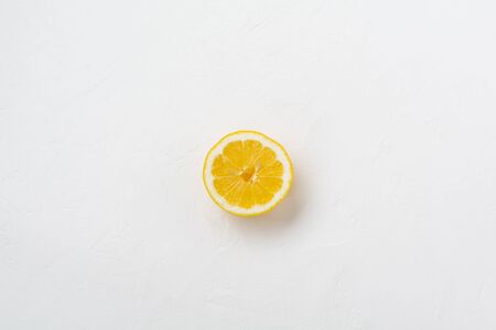 Half lemon on white stone or concrete old background. Top view.の写真素材