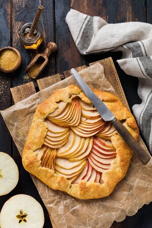 Apple galette, pie, cake with honey and cane sugar on a wooden background. Copy space. Top viewの写真素材