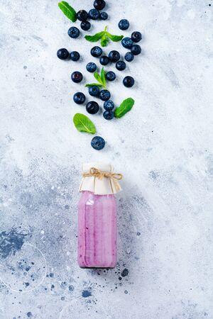 Fresh healthy blueberries smoothie berries and mint in glass jar on light white concrete background. Zero waste concept .Top view. Copy space.の写真素材