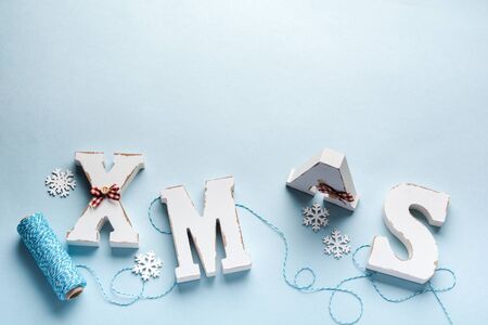 Christmas, New Year decoration, ball, tree, letters xmas with snow on blue background. Copy space. Selective focus.の写真素材