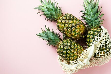 Fresh tree pineapple on pink background. Summer concept. Creative flat lay with copy space. Top view.の写真素材