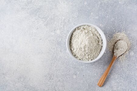 Closed collagen in a ceramic bowl on an old gray concrete background. Flat lay with copy space.の写真素材