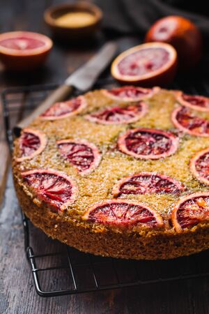 Upside down blood orange cake on old dark concrete background. Rustic stile. Selective focus の写真素材