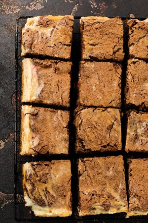 Brownie cheesecake cake with cherry and chocolate on dark background. Top view.の写真素材