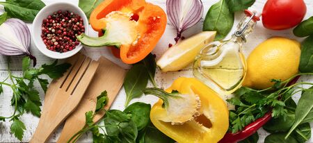 Cooking background. Fresh ingredients for eating vegetables, spices, herbs and olive oil gray...