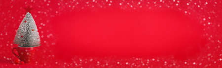 Red coffee cup with Christmas tree. Minimal New Year holidays concept. Space for text. Banner.の写真素材