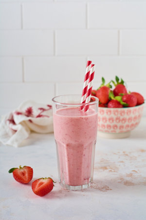 Vegetarian healthy smoothie from strawberry with berries on gray or white concrete background. Selective focus. Space for text.の写真素材
