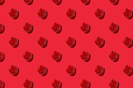 Valentines day seamless pattern of red heart boxes on red background. Greeting card. Good for wallpaper, textile, background, poster, cover of book, post cards.の写真素材
