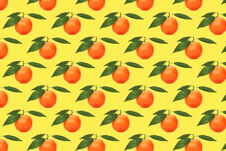 Yellow tangerines pattern on yellow background. Fruit seamless pattern themes for wallpaper, textile, background, poster, cover of book, post cards.の写真素材