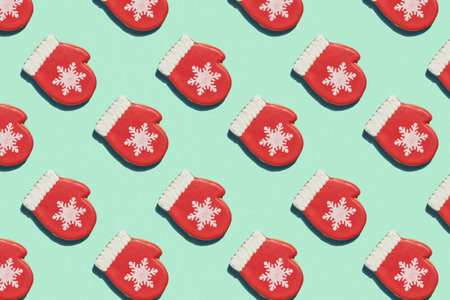 Creative Christmas pattern. Red mitten with snowflake over light green background. Creative Christmas pattern. Top view. Good for wallpaper, textile, background, poster, cover of book, post cards.の写真素材