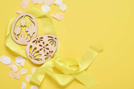 Easter light blue eggs in nest on yellow trend color background. Easter minimal creative horizontal...