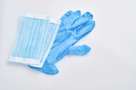 Medical protective mask and disposable gloves isolated on white background.