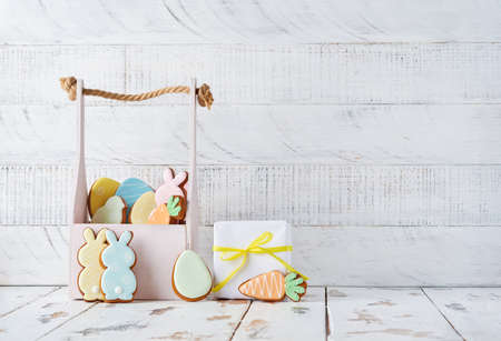 Easter greeting card with colorful colorful rabbits, eggs, chickens and carrots gingerbread cookies...