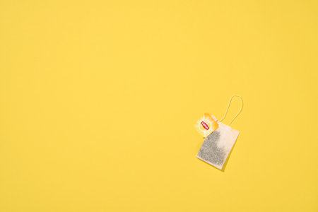 MOGILEV, BELARUS - FEBRUARY 15 2021: Lipton yellow label tea bag on yellow background. Lipton is a British brand of tea owned by Unilever and PepsiCo company.のeditorial素材
