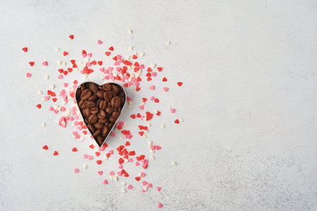 Cooking background with cookie cutters and coffee beans, pink sugar sprinkling on gtay background....