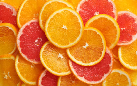 Abstract background of orange and grapefruit citrus slices on white.の写真素材