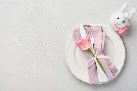 Easter table setting with floral decor on gray table. Elegance dinner. Mock up. Top view.の写真素材