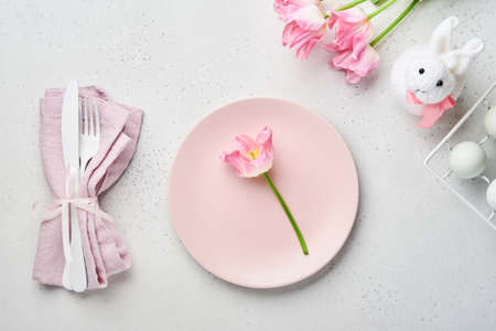 Easter table setting with floral decor on gray table. Elegance dinner. Mock up. Top view.の写真素材