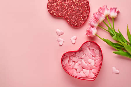 Festive composition with beautiful delicate tulips flowers in pink round box on light background....