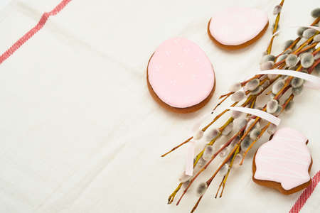 Easter. Pussy willows branches yellow ribbon and easter gingerbread hares, chickens and eggs isolated on a white background.の写真素材