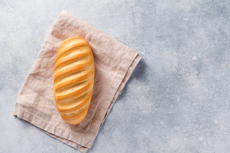 Fresh bread on light gray concrete background. Top view with space for textの写真素材