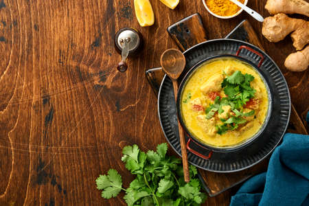 Chicken tikka masala. Traditional of indian cuisine curry and ingredients on dark background. Curry,...