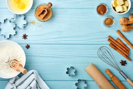 Baking background with ingredients for making gingerbread flour, eggs, kitchen tools, utensils and...