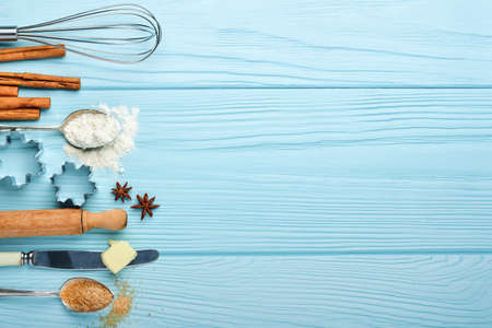 Baking background with ingredients for making gingerbread flour, eggs, kitchen tools, utensils and...