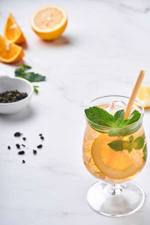 Traditional iced tea with lemon and ice in tall glasses on marble table background Iced tea with lemon. Selective focus. Refreshment cold summer drink.の写真素材