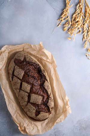 Freshly baked homemade bread on artisan sourdough rye on old light brawn stone or concrete...