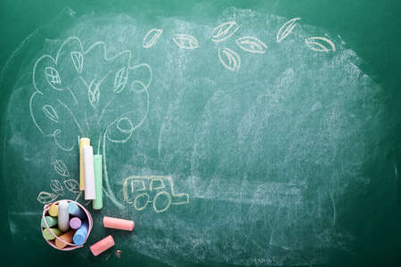 School supplies and black table lamp on green board. Concept back to school. Mock up for design. Copy space. Education Concept.の写真素材