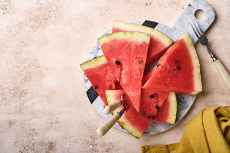Slices of fresh watermelon in plate on light background. Mock up for design. Copy space.の写真素材