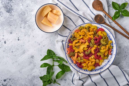 Pasta. italian pasta. Insalata di pasta and vegetables cooking ingredients, cheese, mushrooms and basil on old stone background. Italian food cooking ingredients. Top view with copy space.の写真素材