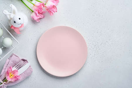 Easter table setting with floral decor on gray table. Elegance dinner. Mock up. Top view.の写真素材