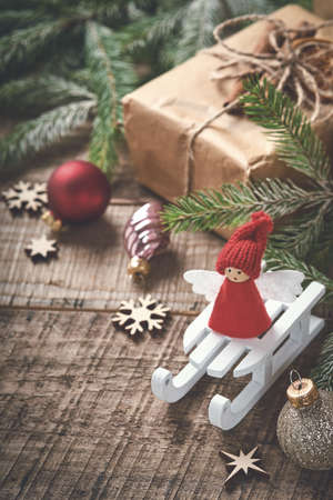 Funny Christmas Angel fir tree branches and gift boxes on winter snowy background with snowy branches. Christmas or Winter concept.の写真素材