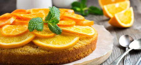 Orange and mandarin cake with polenta, upside down on the old wooden background. Selective focus.の写真素材