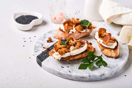 Chanterelle sandwiches with cheese. Open faced sandwich with creamy cheese, seasonings and pepper...